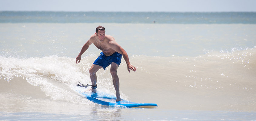 An out of town guest learns to surf with the help of Charleston Surf Lessons. © 2014 Audra L. Gibson. All Rights Reserved.