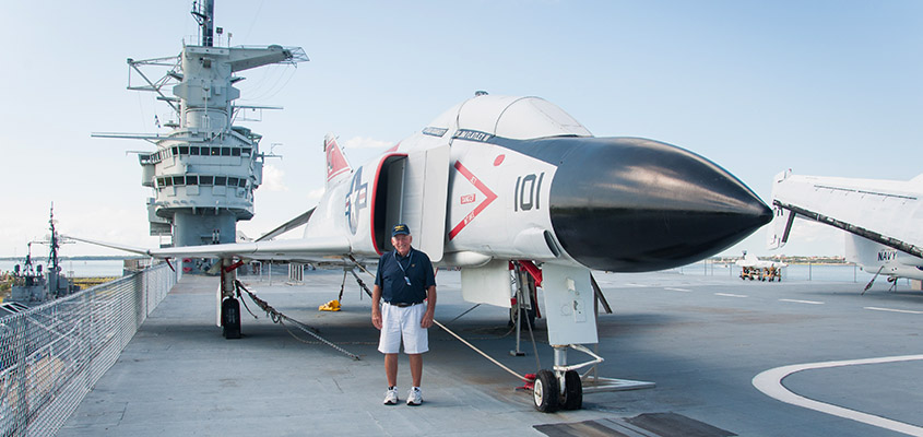 RADM Flatley standing in front of an F4 on the deck of the Yorktown, the equipment he flew in Vietnam. © 2016 Audra L. Gibson. All Rights Reserved.