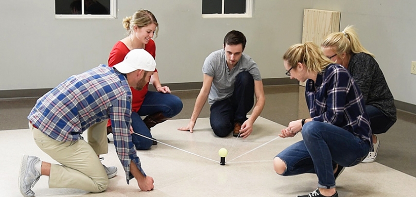 A team works together to get the ball from point A to point B before their competitors.