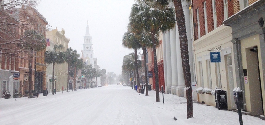 A blanket of snow covers Broad Street as the white steeple of St. Michael&#039;s is camouflaged by snowflakes.