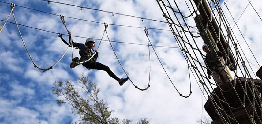 A team member makes her way across the ropes to another member of her group.