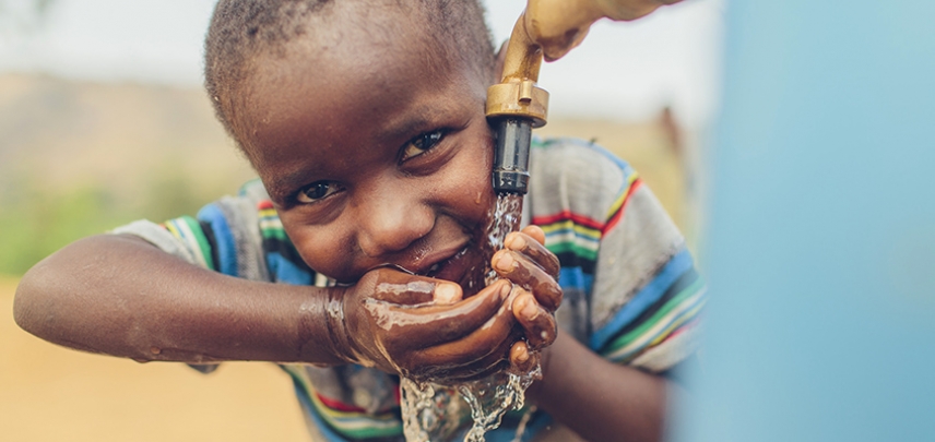 A child in Malawi enjoys clean water.